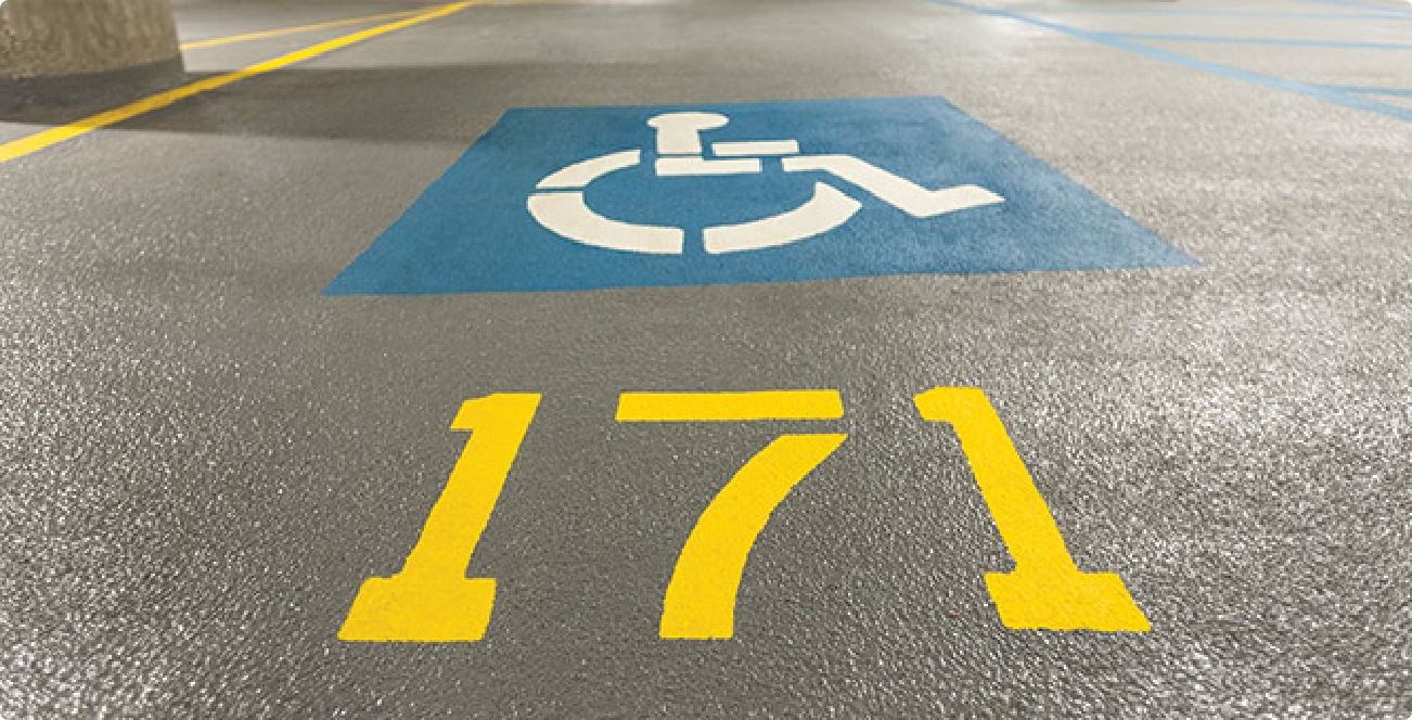 Handicap symbol painted on a treated cement parking garage surfacing